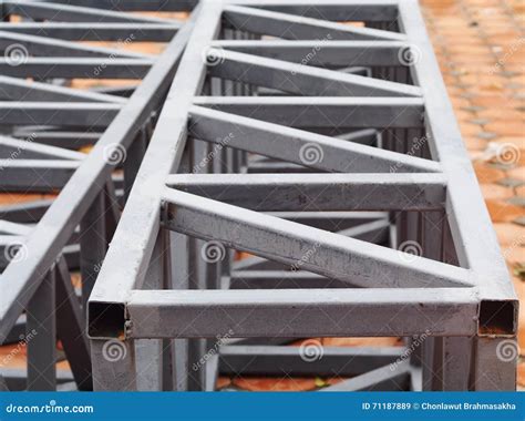 the metal frame of a rectangular box|The metal frame of a rectangular box has a square base. The.